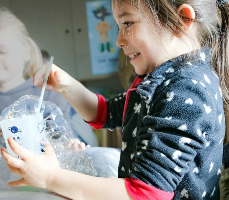 enfant qui fait des bulles de savon