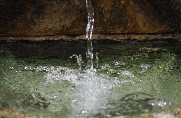 water jet of an ancient stone fountain